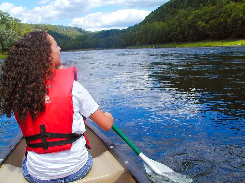 young woman enjoying the scenery while in canoe Indian Head Canoeing Rafting Kayaking Tubing Delaware River