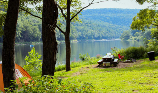 sun reflecting on river surrounded by trees near picnic area Indian Head Canoeing Rafting Kayaking Tubing Delaware River