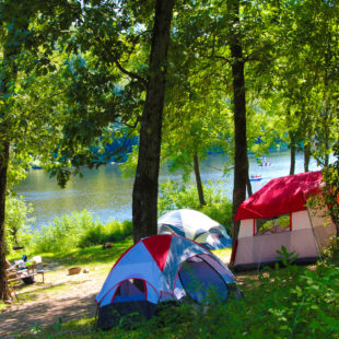 camping tents set up along river with rafters in distance Indian Head Canoeing Rafting Kayaking Tubing Delaware River