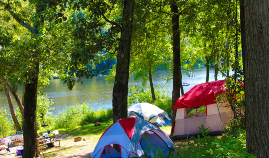 camping tents set up along river with rafters in distance Indian Head Canoeing Rafting Kayaking Tubing Delaware River