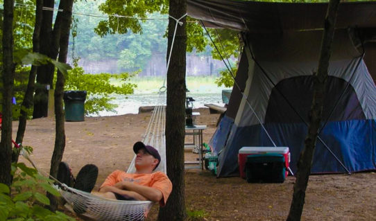 teen male in hammock outside tent Indian Head Canoeing Rafting Kayaking Tubing Delaware River