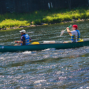 two males in long canoe on river Indian Head Canoeing Rafting Kayaking Tubing Delaware River