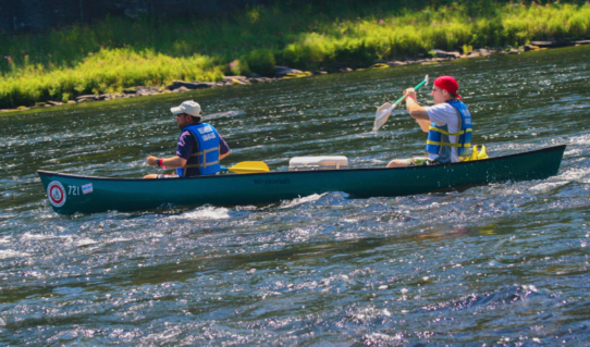 two males in long canoe on river Indian Head Canoeing Rafting Kayaking Tubing Delaware River