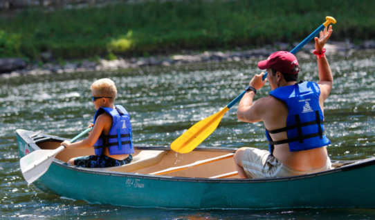 father and son enjoying calm waters in canoe Indian Head Canoeing Rafting Kayaking Tubing Delaware River