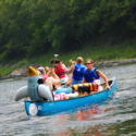 two groups and a dog with life jacket in canoeIndian Head Canoeing Rafting Kayaking Tubing Delaware River