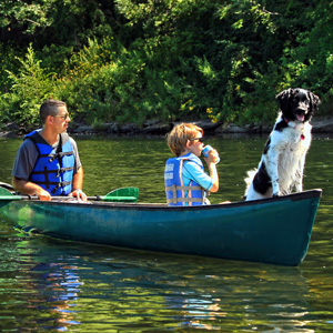 dad son and dog in in green canoe Indian Head Canoeing Rafting Kayaking Tubing Delaware River