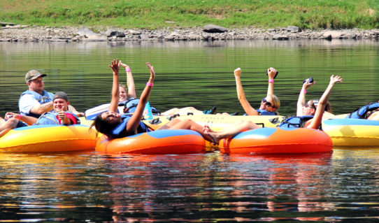 group of 7 enjoying calm waters and scenic views on river Indian Head Canoeing Rafting Kayaking Tubing Delaware River