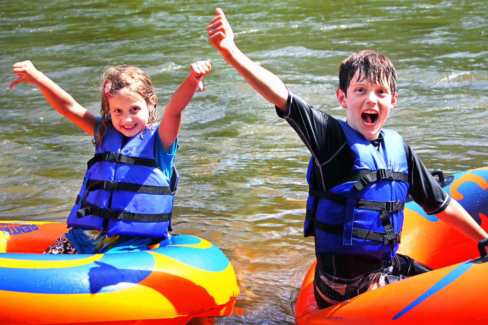 two excited kids in their tubes on the river Indian Head Canoeing Rafting Kayaking Tubing Delaware River