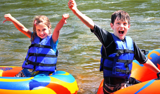 two excited kids in their tubes on the river Indian Head Canoeing Rafting Kayaking Tubing Delaware River