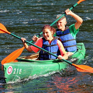 man and woman in friendly race with other kayakers Indian Head Canoeing Rafting Kayaking Tubing Delaware River