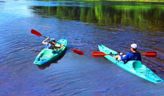 two young men in their own kayaks in Dingmans Ferry Indian Head Canoeing Rafting Kayaking Tubing Delaware River