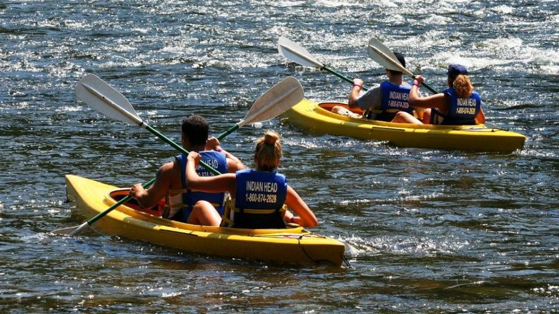two groups on river in kayaks Indian Head Canoeing Rafting Kayaking Tubing Delaware River