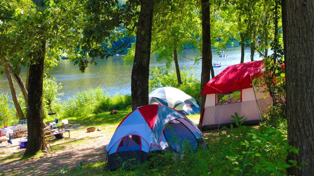 camping tents set up along river with rafters in distance Indian Head Canoeing Rafting Kayaking Tubing Delaware River