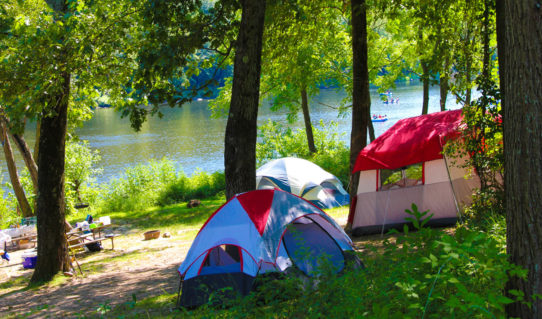 camping tents set up along river with rafters in distance Indian Head Canoeing Rafting Kayaking Tubing Delaware River