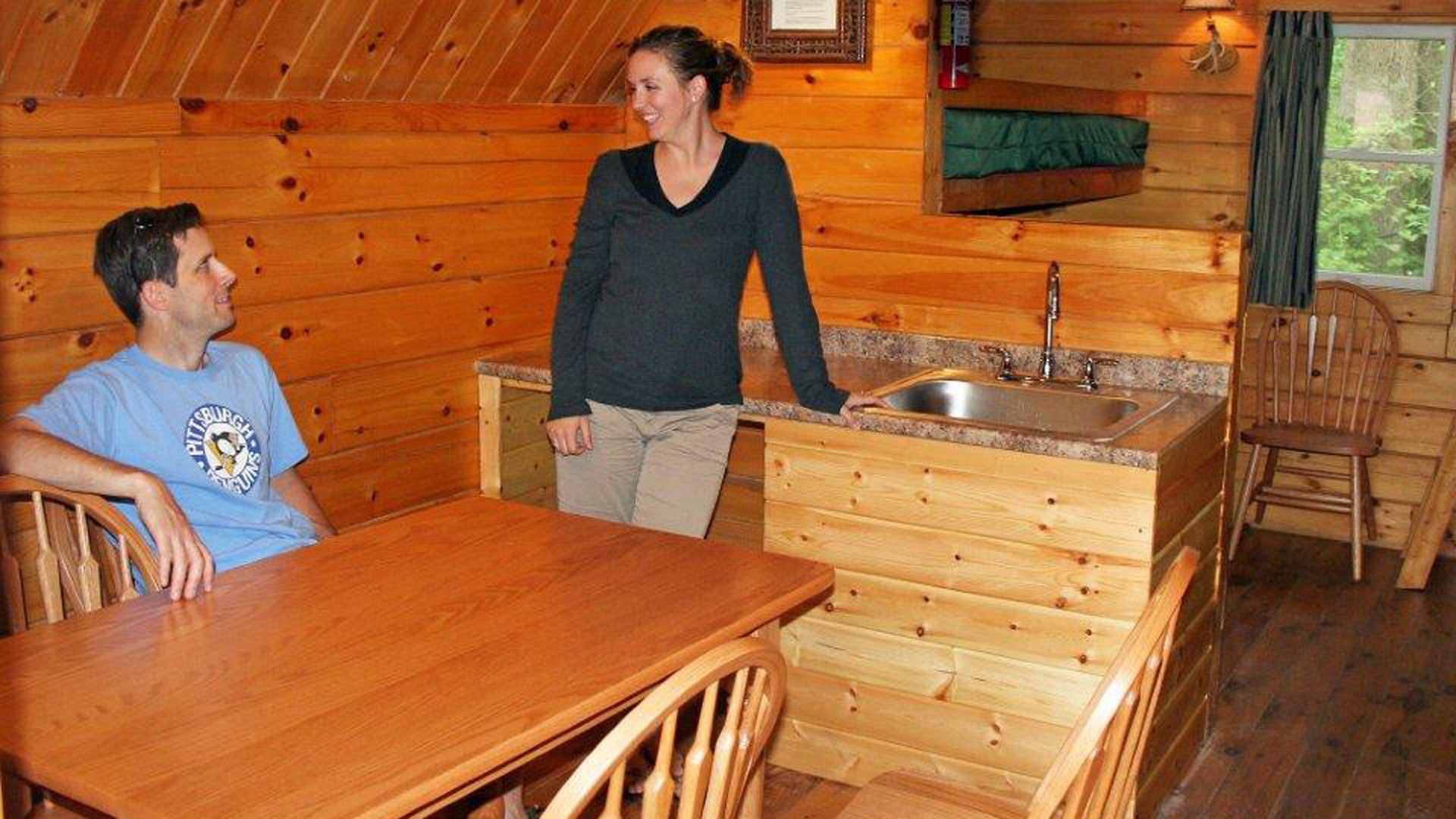 couple in kitchen in log cabin Indian Head Canoeing Rafting Kayaking Tubing Delaware River