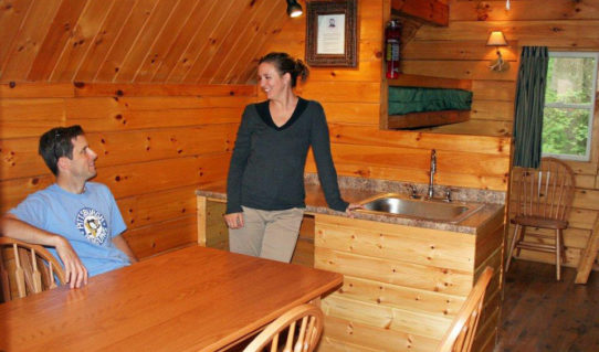 couple in kitchen in log cabin Indian Head Canoeing Rafting Kayaking Tubing Delaware River