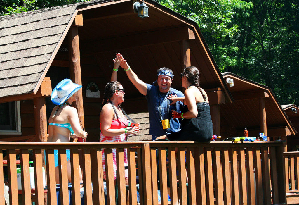 group of friends enjoying the deck in one of our cabins