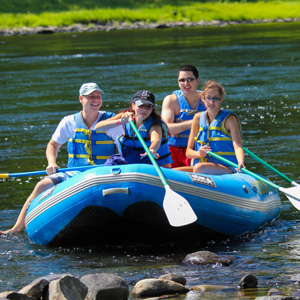group of four in raft coming ashore in Matamoras Indian Head Canoeing Rafting Kayaking Tubing Delaware River