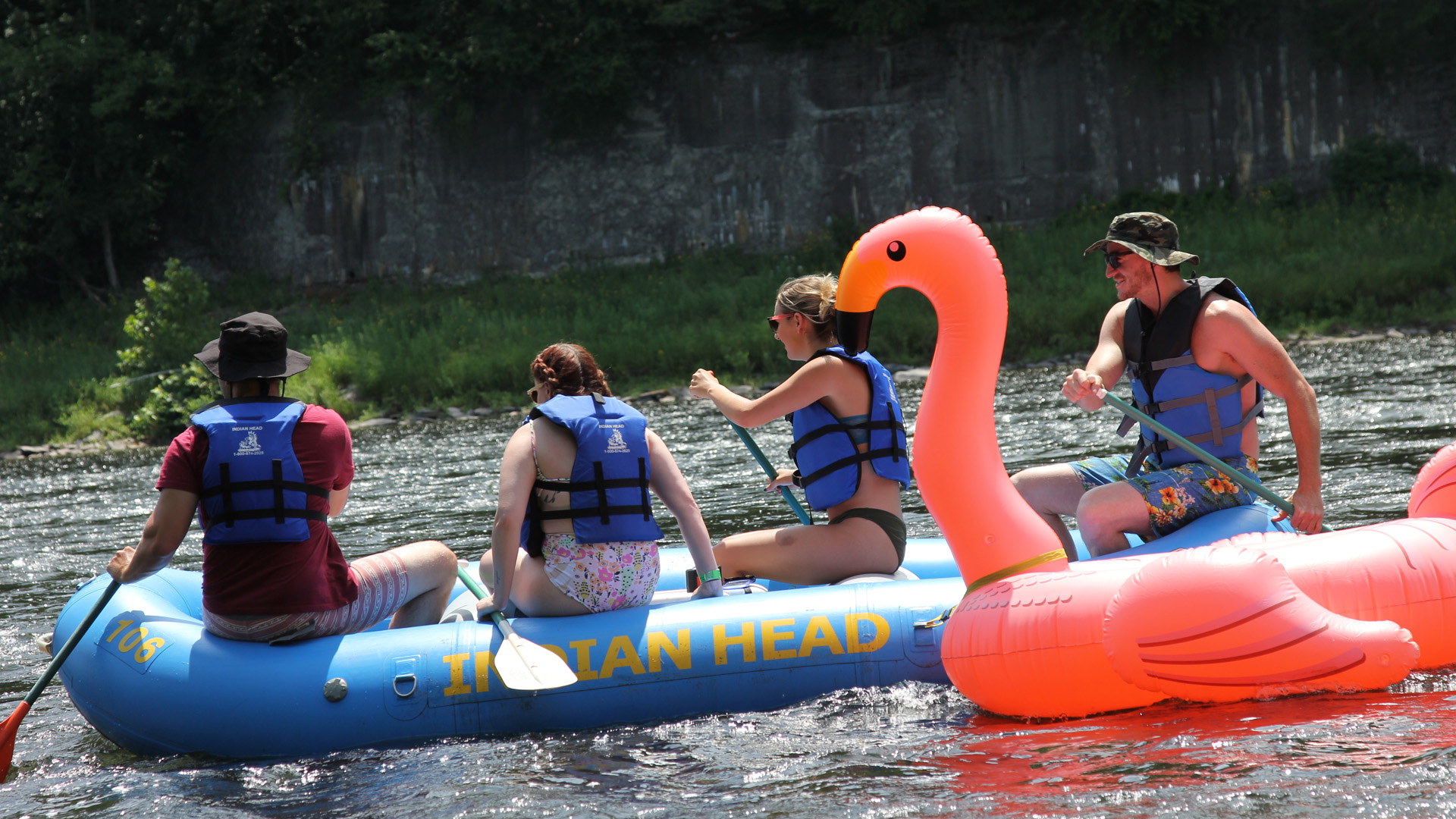 man in flamingo raft coming up on unsuspecting rafters Indian Head Canoeing Rafting Kayaking Tubing Delaware River