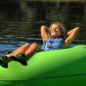 young girl soaking up sun in tube Indian Head Canoeing Rafting Kayaking Tubing Delaware River