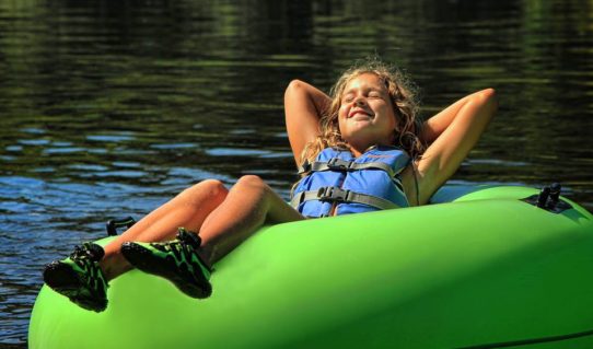 young girl soaking up sun in tube Indian Head Canoeing Rafting Kayaking Tubing Delaware River