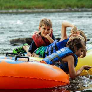 three kids enjoying their tube ride down the river Indian Head Canoeing Rafting Kayaking Tubing Delaware River