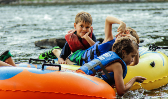 three kids enjoying their tube ride down the river Indian Head Canoeing Rafting Kayaking Tubing Delaware River