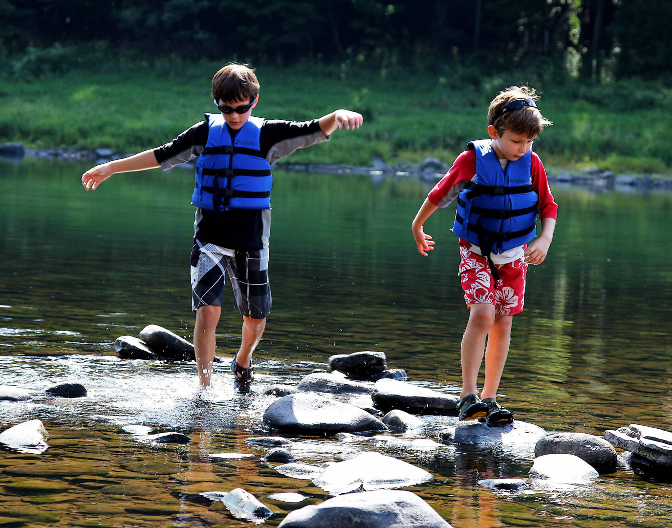 two boys navigating the river rocks Indian Head Canoeing Rafting Kayaking Tubing Delaware River
